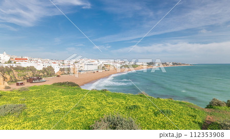 Wide sandy beach and Atlantic ocean in city of Albufeira timelapse. Algarve, Portugal Wide sandy beach and Atlantic ocean in city of Albufeira timelapse. Algarve, Portugal 112353908