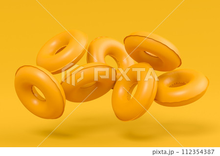 Colorful inflatable ring flying on monochrome background, summer vacation Colorful inflatable ring flying on monochrome background, summer vacation 112354387