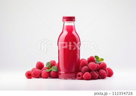 Bottles of fresh raspberry juice and berries lie on a white background isolated 112354728