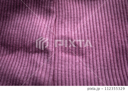 Close-up of purple knit with seam, ribbed, distinct texture, curved fabric Close-up of purple knit with seam, ribbed, distinct texture, curved fabric 112355329
