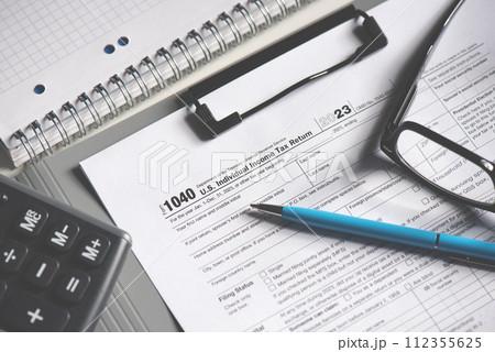 Tax income concept US tax form on table Tax income concept US tax form on table 112355625