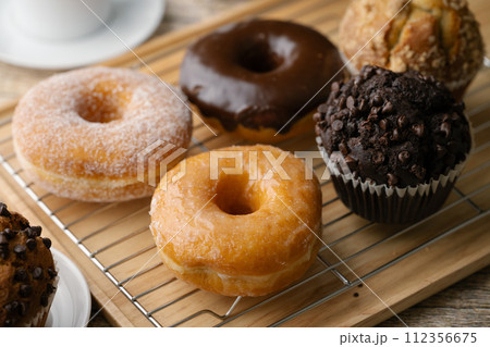 glazed donuts with coffee and muffins 112356675