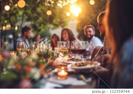 Happy friends having fun outdoor. Group of friends having backyard dinner party together 112359744