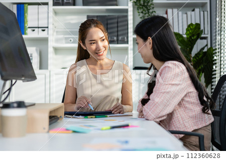 Asian two woman business office discussing financial accounting using tablet working company profits Asian two woman business office discussing financial accounting using tablet working company profits 112360628
