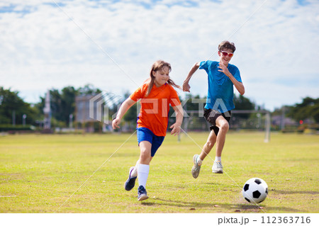 Kids play football. Child at soccer field. 112363716