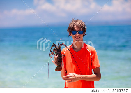 Boy catching fish. Kids fishing on tropical beach. Boy catching fish. Kids fishing on tropical beach. 112363727