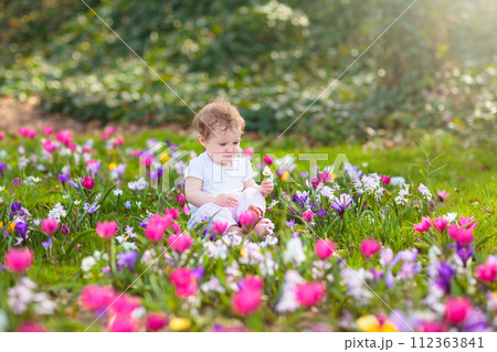 Child in spring park with flowers Child in spring park with flowers 112363841