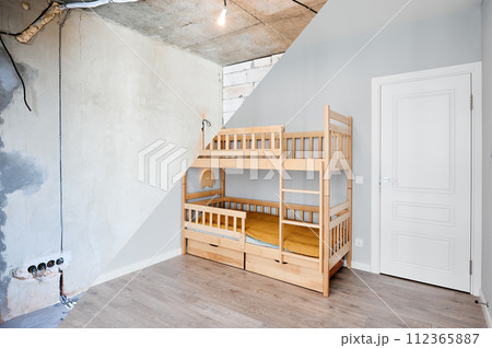 Comparison of children room with wooden bunk bed before and after restoration. Old apartment room with brick wall and new renovated flat with parquet floor and kid house bed. 112365887
