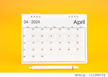 April 2024, Monthly desk calendar for 2024 year and pen on yellow background. 112366728