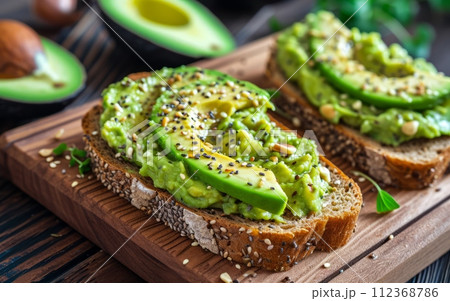 Avocado toast on a wooden cutting board 112368786