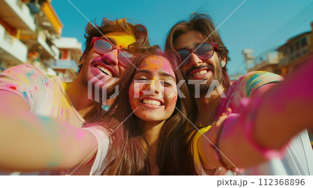 A group of friends capture their Holi happiness in a selfie, against the backdrop of their city, celebrating spontaneity and friendship A group of friends capture their Holi happiness in a selfie, against the backdrop of their city, celebrating spontaneity and friendship 112368896