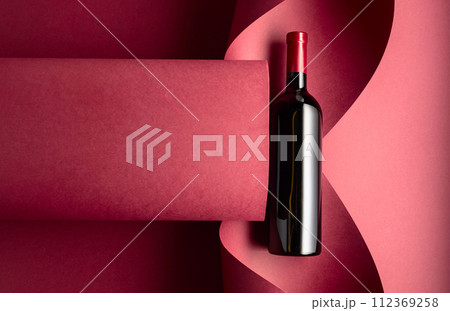 Bottle of red wine on a red background. Bottle of red wine on a red background. 112369258