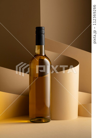 Bottle of white wine on a beige background. Bottle of white wine on a beige background. 112369266