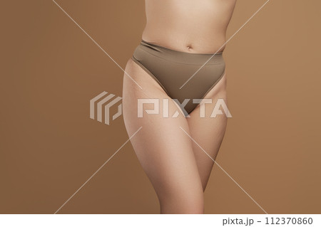 Cropped image female body in green underwear 112370860