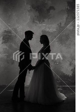 Art fashion studio photo of wedding couple silhouette groom and bride on colors background. 112371385