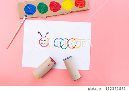 a piece of paper sitting on top of a table, a child's drawing, action painting, the caterpillar, circle, made of cardboard, having a good time a piece of paper sitting on top of a table, a child's drawing, action painting, the caterpillar, circle, made of cardboard, having a good time 112371881