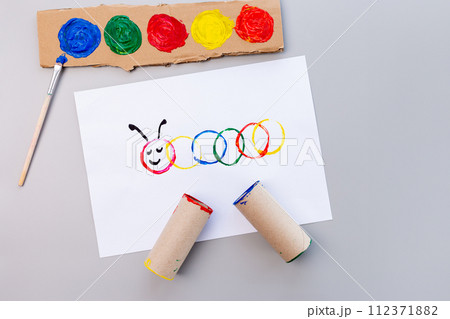 a piece of paper sitting on top of a table, a child's drawing, action painting, the caterpillar, circle, made of cardboard, having a good time 112371882