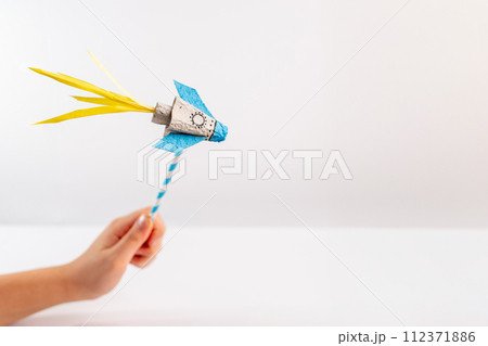 a close up of a person holding a paper rocket, with a white background, a close up of a person holding a paper rocket, with a white background, 112371886
