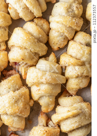 Homemade bagel cookies with dried fruits and walnuts close up top view. Sweet croissant cookies Homemade bagel cookies with dried fruits and walnuts close up top view. Sweet croissant cookies 112373557