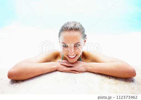 Portrait, edge and woman with a smile, swimming pool and vacation with weekend break, relax and happiness. Face, wet and person with joy, swimming and relax with holiday, getaway trip, calm or summer 112373962