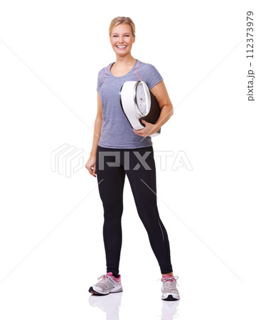 Exercise, scale and portrait of woman with smile, workout and wellness with healthy pride in studio. Health, fitness and body of happy girl with weight loss measurement isolated on white background. 112373979