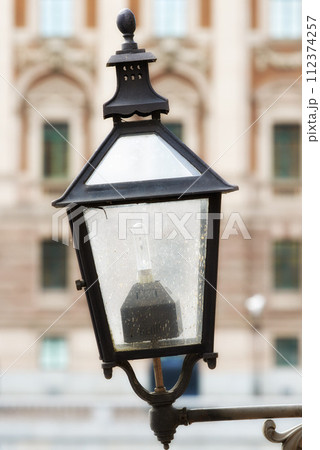 Travel, architecture and lamp on vintage wall in old town with history, culture or holiday destination in Sweden. Vacation, landmark and antique lantern in Stockholm with retro light ancient city 112374257