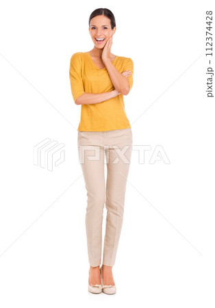 Woman, fashion and portrait for beauty, excited and happy in outfit in studio for minimalist style. Female person, smile and yellow top by white background, hand on face and confident in apparel 112374428