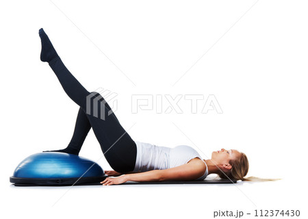 Fitness, half ball and woman doing floor exercise, studio workout or pilates stability challenge on ground. Gym equipment, sports exercise and athlete legs raise for core training on white background 112374430