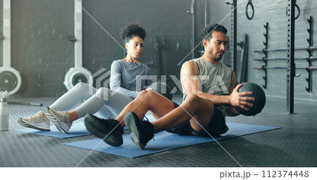 Fitness, energy and friends on gym floor with weight ball for training, power and exercise together. Cross, workout and black woman with man for sports, power and cardio in strength, core and mindset 112374448