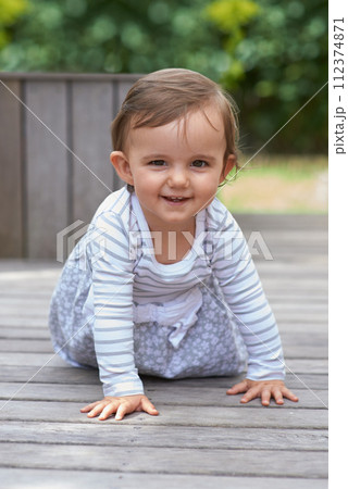 Baby girl, crawling outside and portrait on floor, child development and growth with sensory coordination. Girl, cognition and healthy in good mood, childhood or balance with arms, kid or adorable 112374871