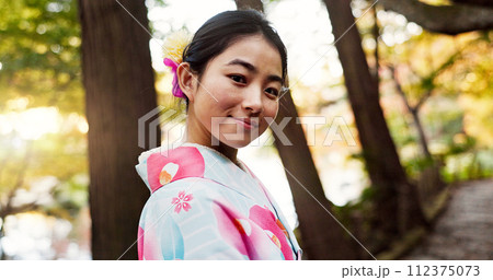 Japanese woman, portrait and kimono in forest with smile, pride and traditional clothes for culture on walk. Girl, person and happy with indigenous fashion, style or outdoor by trees, woods or nature 112375073