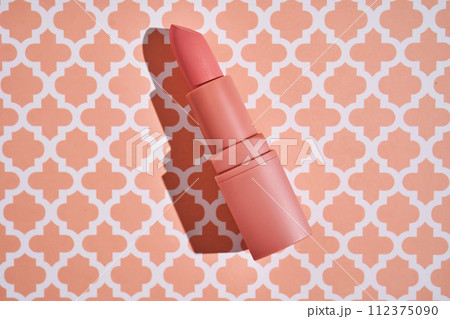 Peach lipstick on a peach background. 112375090
