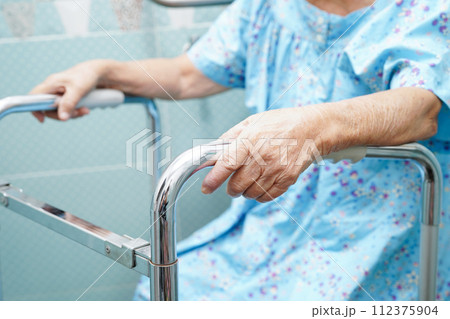 Asian elderly old woman patient use toilet support rail in bathroom, handrail safety grab bar, security in nursing hospital. Asian elderly old woman patient use toilet support rail in bathroom, handrail safety grab bar, security in nursing hospital. 112375904