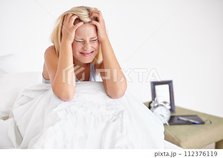 Stress, headache and woman in a bed waking up with anxiety, panic attack or fear at home. Fatigue, mental health and female person in a bedroom frustrated by insomnia, pressure or nightmare trauma Stress, headache and woman in a bed waking up with anxiety, panic attack or fear at home. Fatigue, mental health and female person in a bedroom frustrated by insomnia, pressure or nightmare trauma 112376119