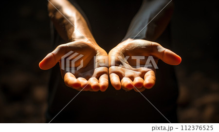 outstretched hands closeup black background 112376525