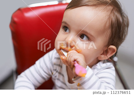 Eating, cute and boy baby in chair with vegetable food for child development at home. Sweet, nutrition and hungry young kid or toddler enjoying healthy lunch, dinner or supper meal at house. Eating, cute and boy baby in chair with vegetable food for child development at home. Sweet, nutrition and hungry young kid or toddler enjoying healthy lunch, dinner or supper meal at house. 112376651