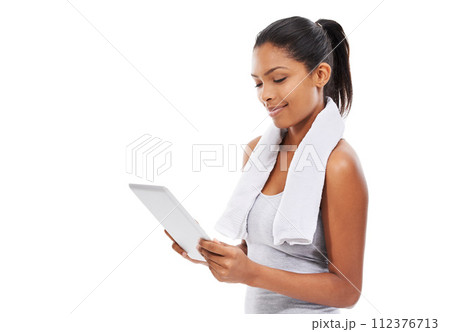 Exercise, internet and woman with tablet, healthy and smile isolated on a white studio background. Person, girl and model with tech, connection and online with information, wellness, fitness or towel 112376713