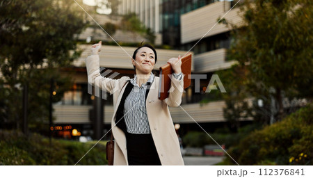 City, business and woman with celebration, dancing and achievement with winner, promotion and employee. Japan, person or entrepreneur with b2b deal, victory or bonus with energy, freedom or happiness 112376841