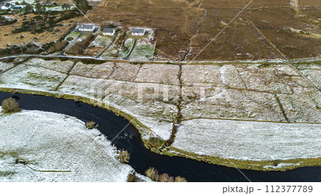 Aerial view of a snow covered Ardara and Owenea river in County Donegal - Ireland 112377789
