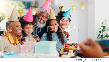 Cake, happy and family at birthday party celebration together at modern house with candles. Smile, excited and young children with African father and grandparents with hats for photograph at home. 112377908