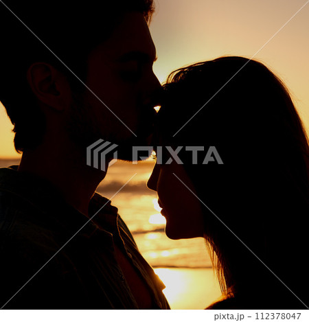 Couple, love and silhouette embrace on beach at sunset or healing relationship environment, vacation or explore. Happy partnership, hug and shadow at water for forehead kiss for nature, ocean or trip Couple, love and silhouette embrace on beach at sunset or healing relationship environment, vacation or explore. Happy partnership, hug and shadow at water for forehead kiss for nature, ocean or trip 112378047