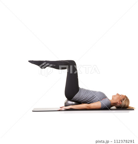 Exercise legs, pilates and woman on ball in workout, training or healthy body isolated on a white studio background mockup space. Core, mat and person on equipment for balance, sports and fitness 112378291
