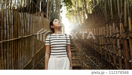 Nature, bamboo path and Japanese woman for hiking on holiday, vacation and morning in outdoor woods. Thinking, relax and person in forest, track and trail to explore, walking and adventure in Kyoto Nature, bamboo path and Japanese woman for hiking on holiday, vacation and morning in outdoor woods. Thinking, relax and person in forest, track and trail to explore, walking and adventure in Kyoto 112378568