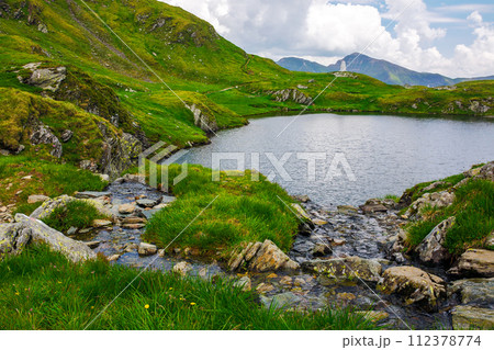 capra lake of fagaras range on a cloudy day. summer nature background in mountain of romania. popular travel destination of transylvania alps 112378774