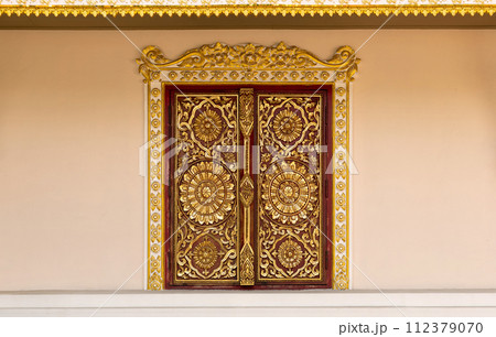 Pattern of flower carved on wood window, Thai art style in temple 112379070