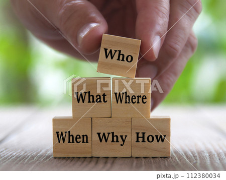 Hand stacking wooden blocks with text - How, Why, What, When, Where, Who. Fact finding concept. Hand stacking wooden blocks with text - How, Why, What, When, Where, Who. Fact finding concept. 112380034