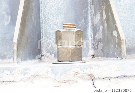 Old big Metal male square nut screw nail heads stackable to attach to large light pole bases. Bolts and screws. To attach structure of wall to be strong for house or various industrial.	 112380876