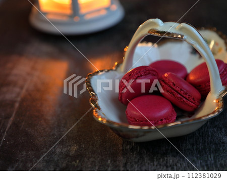 Macaroons and lantern moody food background. Macaroons and lantern moody food background. 112381029