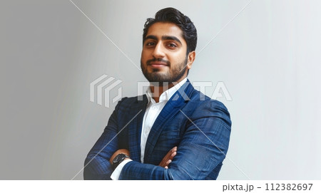 AI-generated content. Businessman standing with crossed arms on gray, with a confident bearded Indian investor, executive, professional lawyer, banker, and businessman. 112382697