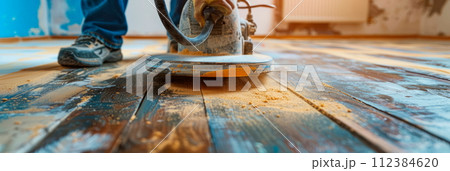 Sanding surfaces close-up of a worker using sandpaper or a sander to smooth surfaces before painting or refinishing 112384620